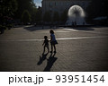 Girl 6 year with little brother 1-2 year old toddler boy having fun near fountain in Katowice 93951454
