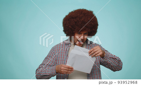 Man open envelope letter reads it feel happy, career growth advance promotion, bank loan approve 93952968