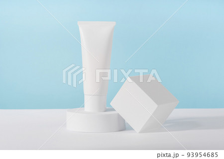 Cosmetic luxury cream tube bottle mockup on blue background on pedestal podium. Unbranded lotion beauty product packaging. Product presentation mock up. Lotion, mousse, cleanser for skincare 93954685