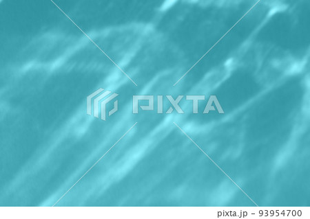 Caustic effect light refraction on blue wall overlay photo mockup, blurred sun rays refracting through glass prism with shadow. Abstract natural light refraction silhouette on water surface 93954700