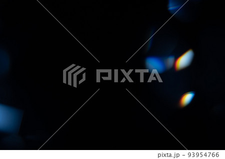 Blue light flare prism rainbow flares overlay effect on black background, light crossing crystals, prismatic sun catcher reflections rays. Abstract blurred colourful lens flare bokeh on dark Blue light flare prism rainbow flares overlay effect on black background, light crossing crystals, prismatic sun catcher reflections rays. Abstract blurred colourful lens flare bokeh on dark 93954766