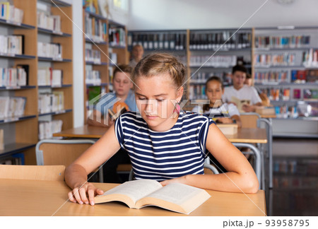 Schoolers reading in college library Schoolers reading in college library 93958795