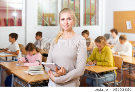 Portrait of positive female school teacher 93958830