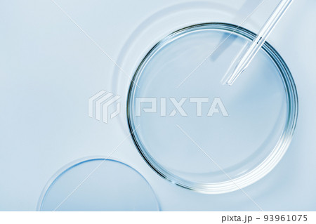 Empty round petri dish or glass slide and Pipette on blue background. Mockup for cosmetic or scientific product sample Empty round petri dish or glass slide and Pipette on blue background. Mockup for cosmetic or scientific product sample 93961075
