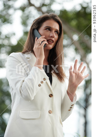 Portrait of young businesswoman talking on phone to discuss project details 93962585