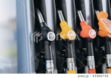 petrol pump filling fuel nozzles at gas station petrol pump filling fuel nozzles at gas station 93966748