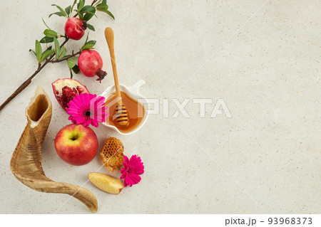 Rosh hashanah, jewish New Year holiday concept. Pomegranate, apples and honey traditional products for celebration 93968373