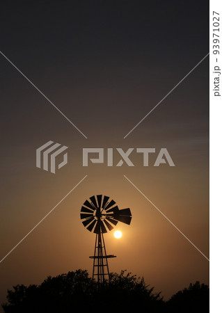 Windmill Sunset with a colorful sky and the Sun Windmill Sunset with a colorful sky and the Sun 93971027