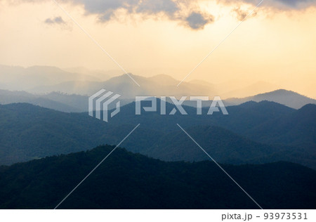 colorful dramatic sky with cloud at sunset. morning fog in dense tropical rainforest 93973531