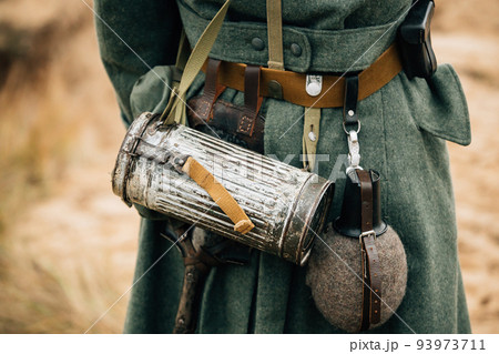 Re-enactor Dressed As German Wehrmacht Infantry Soldier In World War Ii On Marsch. View From Back. German Military Dress Of A German Soldier At World War II 93973711