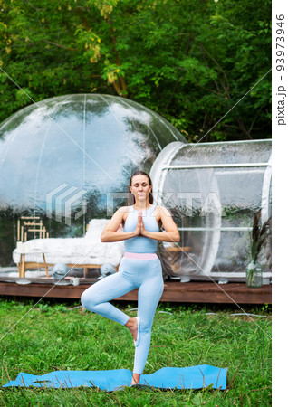Transparent bubble tent and woman doing yoga at glamping Transparent bubble tent and woman doing yoga at glamping 93973946