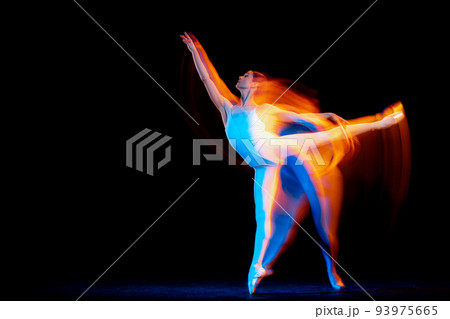 Young and graceful female ballet dancer dancing over dark background in mixed neon light. Art, motion, action, flexibility, inspiration concept. 93975665