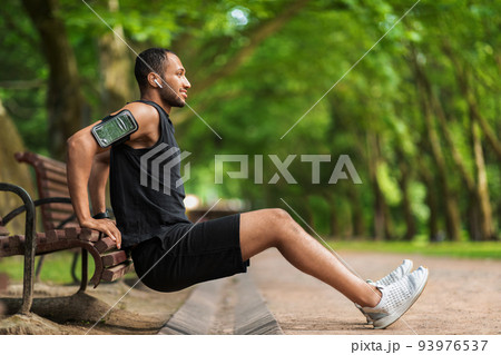 Hot athletic black man exercising in the park, side view 93976537