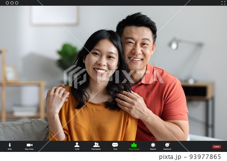 Cheerful korean couple having video conference with friends, screenshot 93977865
