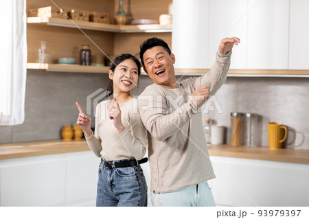 Crazy japanese couple having fun together at kitchen Crazy japanese couple having fun together at kitchen 93979397