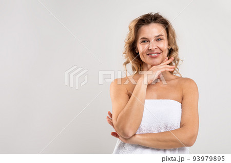 Female Beauty. Attractive Middle Aged Woman Wrapped In Towel Posing In Studio Female Beauty. Attractive Middle Aged Woman Wrapped In Towel Posing In Studio 93979895