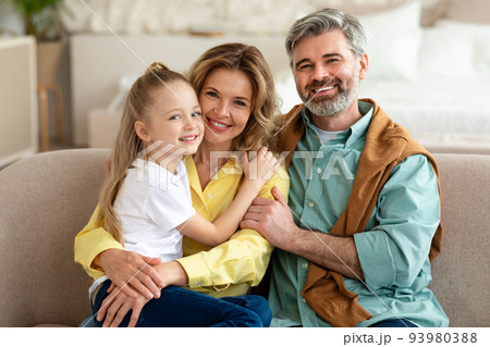 Happy Family With Little Daughter Posing Embracing At Home 93980388