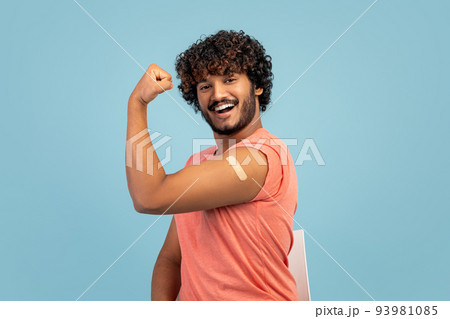 Handsome indian man showing biceps with adhesive plaster on Handsome indian man showing biceps with adhesive plaster on 93981085