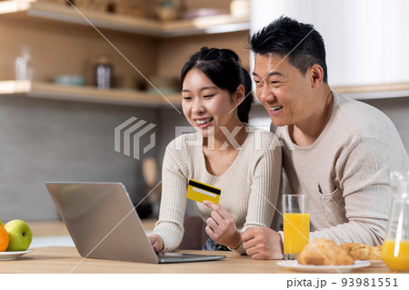 Cute japanese family shopping from home while having breakfast Cute japanese family shopping from home while having breakfast 93981551