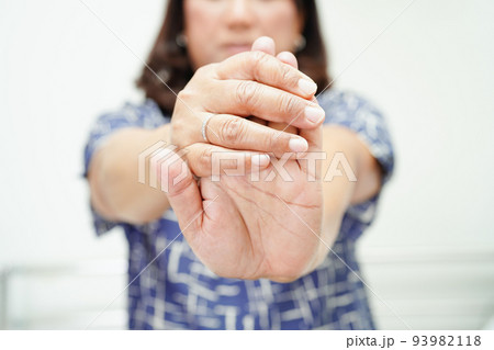 Asian senior woman pain her hand and finger, De Quervain's tenosynovitis. Asian senior woman pain her hand and finger, De Quervain's tenosynovitis. 93982118