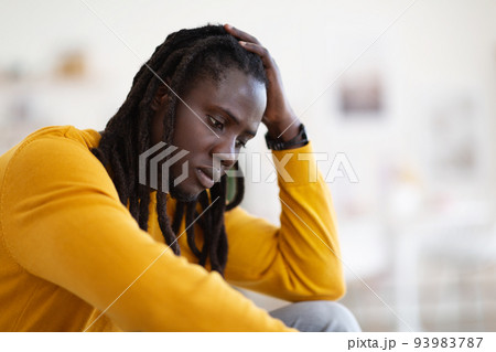 Closeup Portrait Of Depressed African American Guy Sitting At Home 93983787