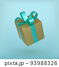 Christmas golden gift box with turquoise ribbon bow. 93988326