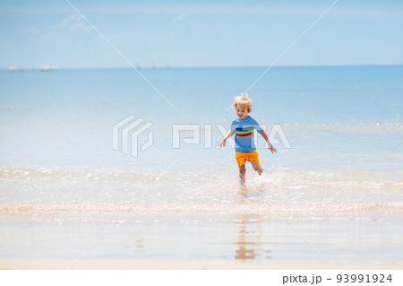 Kids playing on beach. Children play at sea. 93991924