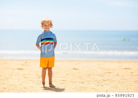 Kids playing on beach. Children play at sea. 93991925