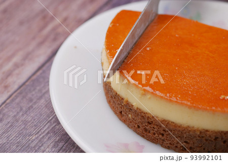 Caramel custard pudding on a plate on table  93992101