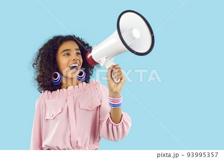 Happy child speaking through megaphone and making loud announcement about fashion sale 93995357