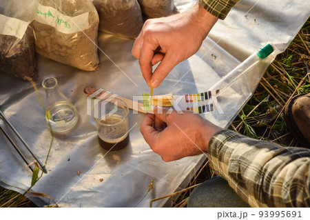 Agronomy specialist testing soil sample labortory equipment outdoors 93995691