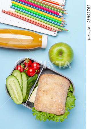 Lunch box with sandwich, vegetables and juice 93995762