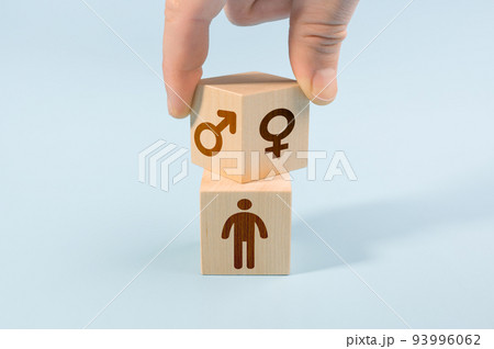 selection or changing gender concept. hand turns cube with the male and female icons over the cube with human icon 93996062