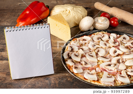 Delicious homemade uncooked pizza. Homemade pizza food photography recipe on rustic background. Delicious homemade uncooked pizza. Homemade pizza food photography recipe on rustic background. 93997289