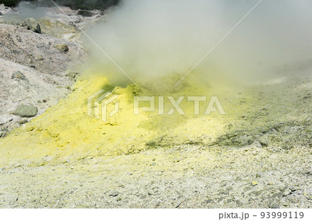 smoking solfatara among sulfur deposits on the slope of the volcano smoking solfatara among sulfur deposits on the slope of the volcano 93999119