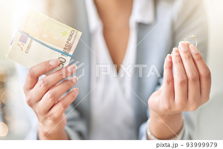 Money, finance or cash and divorce, wedding or ring in the hands of a woman, bride or wife with a decision or choice. Family law with a female leaving a marriage for mental health and holding payment 93999979