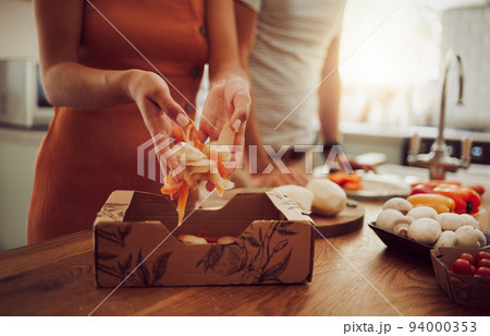 Recycle, sustainability and eco friendly cooking with a couple preparing food in the kitchen at home. Health, wellness and eating with a vegan man and woman recycling fresh, vegetarian produce 94000353