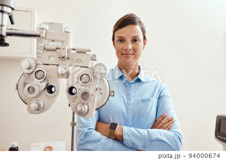 Confident, happy and proud optometrist standing with arms crossed, ready for checkup and preparing equipment in an optometry office. Smiling, successful and wellness portrait of an ophthalmologist Confident, happy and proud optometrist standing with arms crossed, ready for checkup and preparing equipment in an optometry office. Smiling, successful and wellness portrait of an ophthalmologist 94000674