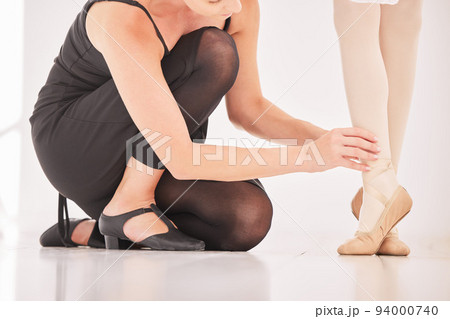 Ballet girl legs with teacher or coach teaching and training in studio for student competition performance. Learning young dancer in coaching dancing at dance class, academy or school for balance 94000740