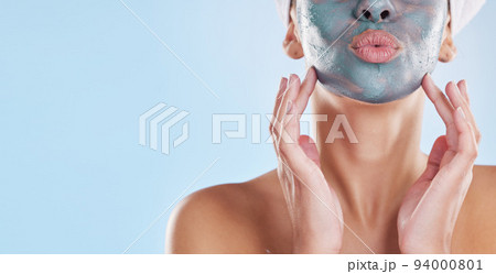 Facial, beauty and skincare with woman and face mask for clear skin, acne or luxury cosmetics against a blue background. Wellness, spa and relax with female and salon face treatment product Facial, beauty and skincare with woman and face mask for clear skin, acne or luxury cosmetics against a blue background. Wellness, spa and relax with female and salon face treatment product 94000801