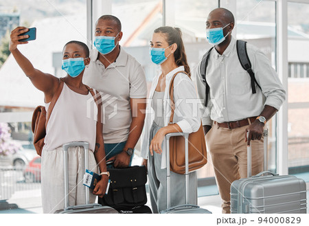 Travel people taking selfie with covid face mask at the airport on their trip, travel or holiday overseas. Group of people or friends with suitcase, phone and social media memories while on vacation Travel people taking selfie with covid face mask at the airport on their trip, travel or holiday overseas. Group of people or friends with suitcase, phone and social media memories while on vacation 94000829