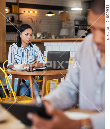 Working, reading and typing in a coffee shop with a digital worker writing an email on a computer. Job, career focus of a woman startup entrepreneur or digital web writer in a cafe or restaurant 94000951