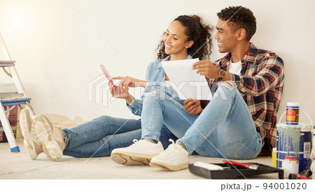 Paint, painting and room color choice for home improvement project for home, apartment or property. New home upgrade with happy couple with a smile on the floor excited about new home maintenance job 94001020