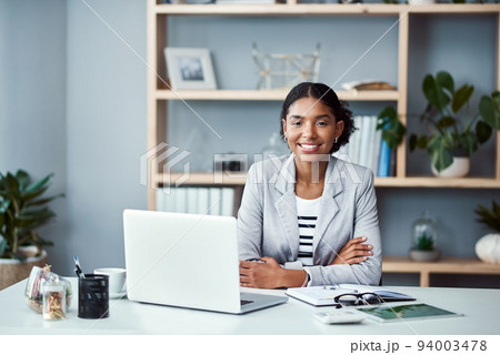 Happy, confident and successful business woman ready to lead startup company and start working on laptop. Proud and powerful CEO or African American entrepreneur sitting at an office desk. Happy, confident and successful business woman ready to lead startup company and start working on laptop. Proud and powerful CEO or African American entrepreneur sitting at an office desk. 94003478