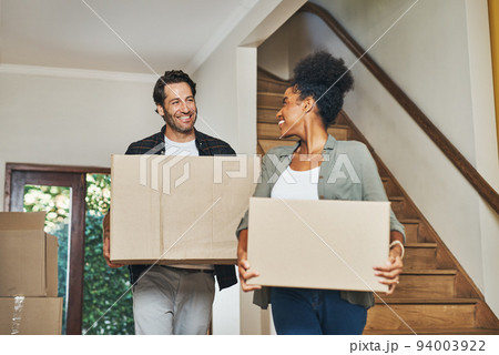 Couple homeowners moving in, carrying boxes and unpacking in new purchased home as real estate investors. Smiling, happy and cheerful interracial man and woman, first time buyers and property owners Couple homeowners moving in, carrying boxes and unpacking in new purchased home as real estate investors. Smiling, happy and cheerful interracial man and woman, first time buyers and property owners 94003922