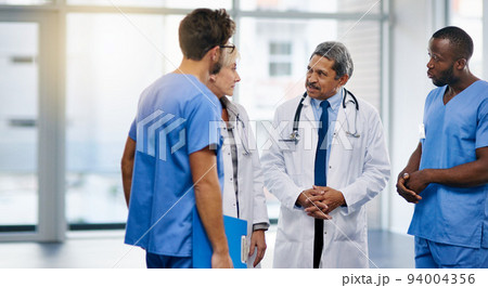 Talking doctors, medical professionals and healthcare workers planning or brainstorming hospital medicine treatment. Diverse group of frontline clinic colleagues discussing new breakthrough in virus 94004356