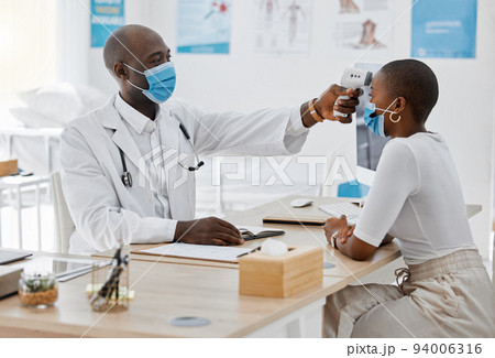 Doctor checking temperature of covid patient while testing for high fever symptoms of sick, flu or illness. Screening woman for a healthcare consult, checkup and visit in a hospital or medical clinic Doctor checking temperature of covid patient while testing for high fever symptoms of sick, flu or illness. Screening woman for a healthcare consult, checkup and visit in a hospital or medical clinic 94006316