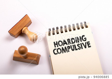 Hoarding Compulsive text written on a notebook. Stamps on a white background Hoarding Compulsive text written on a notebook. Stamps on a white background 94006885