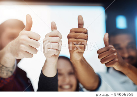 Teamwork, support and trust with a thumbs up from happy colleagues collaborating. Excited partners uniting, showing trust and success with a winning gesture. Community working together towards a goal 94006959