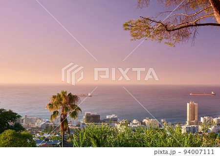 Copy space, sunset sky and city view of sea or ocean background with building infrastructure in a travel destination. Scenery of Cape Town downtown centre and urban cityscape architecture at sunrise 94007111